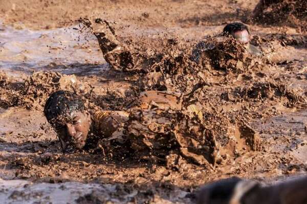 Army training exercising in mud